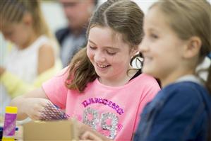 two children work with craft items