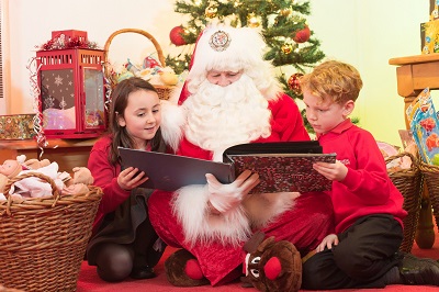 Santa reading to two children