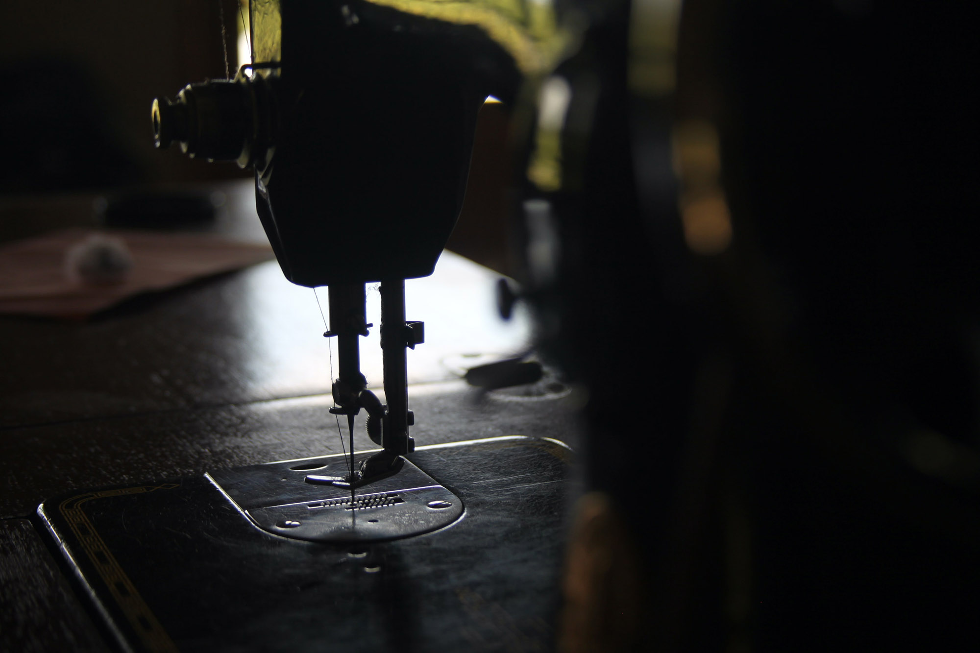 A close up of the needle and mechanism on a sewing machine