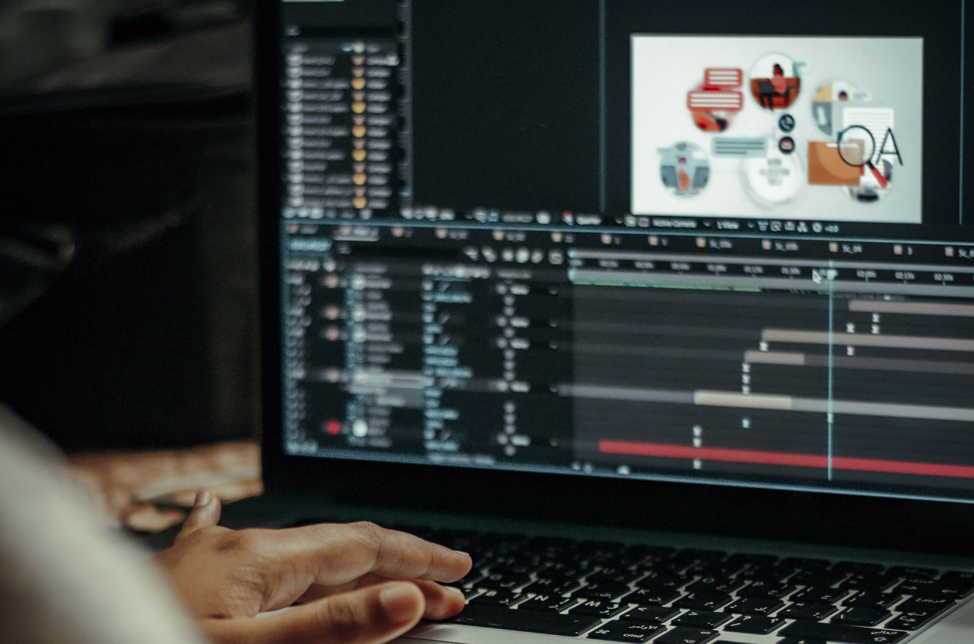 A person working at a computer with video editing software on the screen