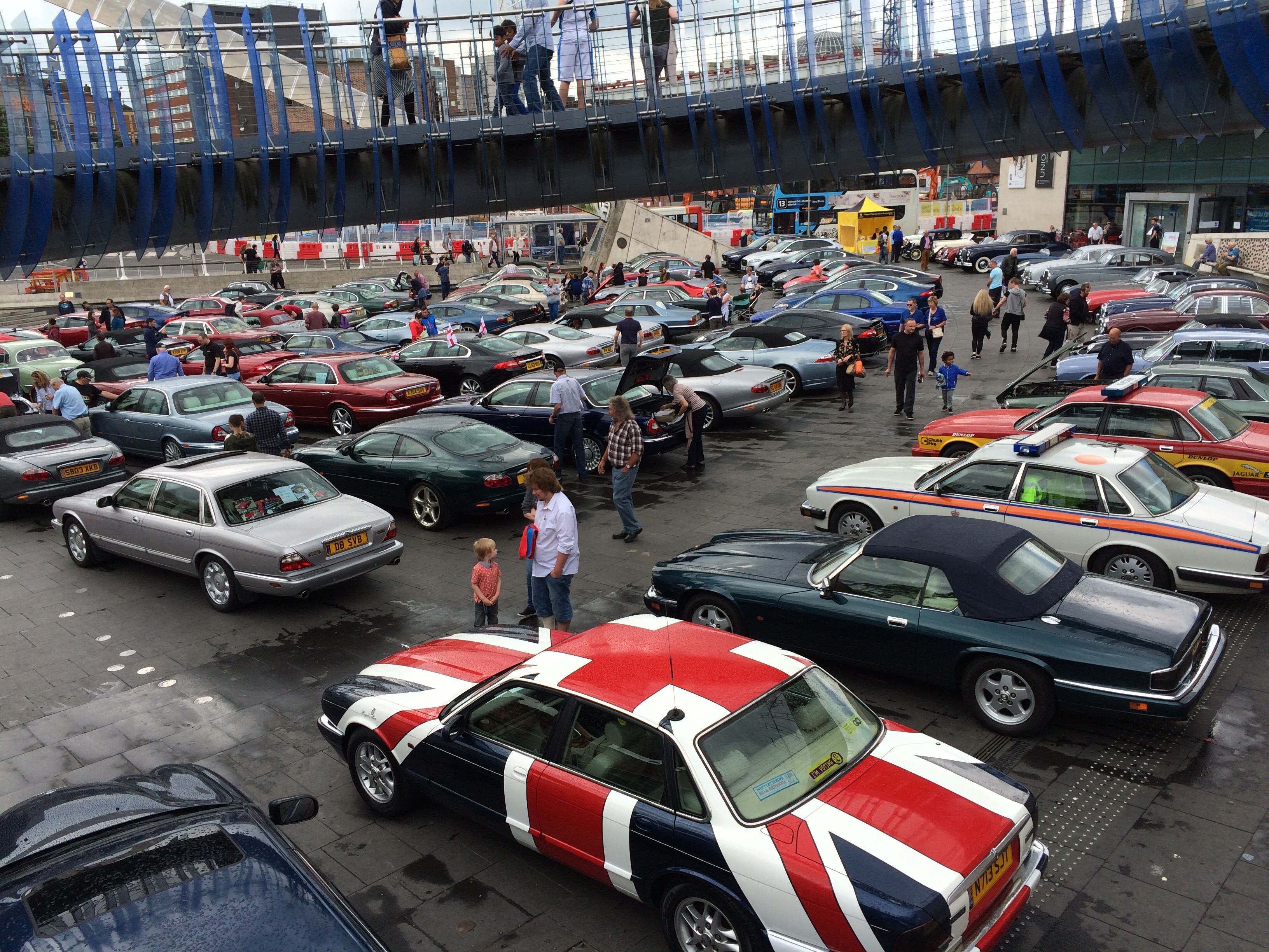  a display of Jaguar cars fills the space outside the Museum